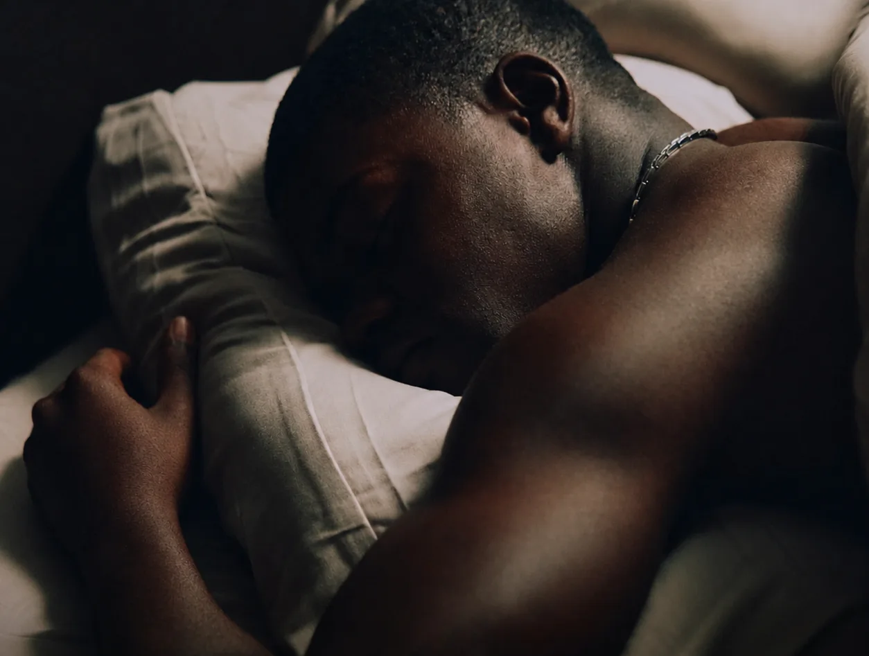 Asleep, face down on a pillow, early in the morning